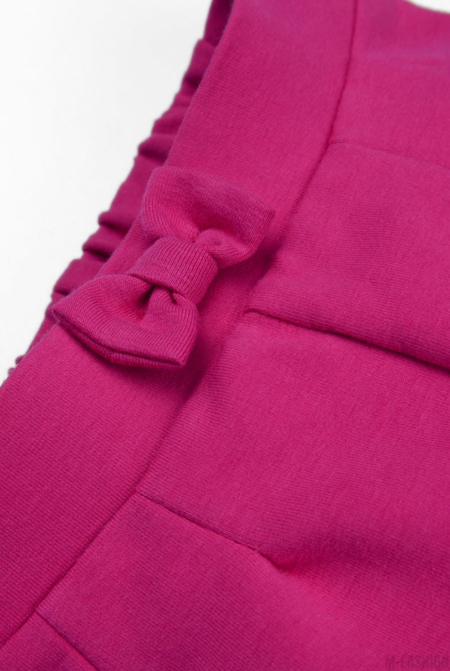 Розовые брюки из футера с бантом на резинке и подворотами- Фото 5