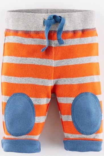Оранжевые котоновые штаны с аппликацией на коленях и подворотами