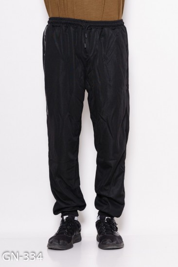 Черные свободные штаны на манжетах с декоративной вставкой на кармане с молнией